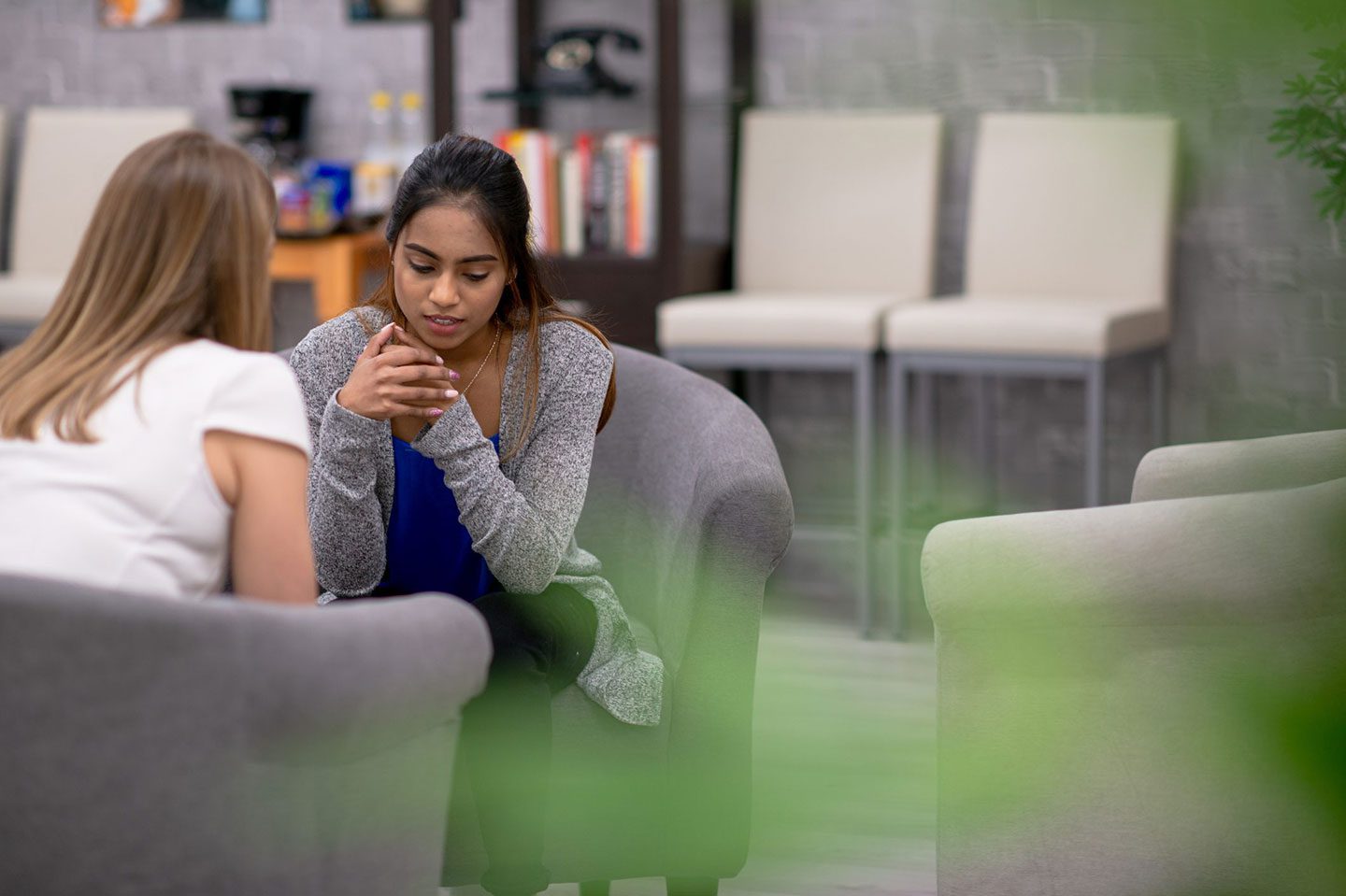 inpatient-program-preparation A young girl leans forward in her love seat as she speaks to a blonde woman sitting across from her